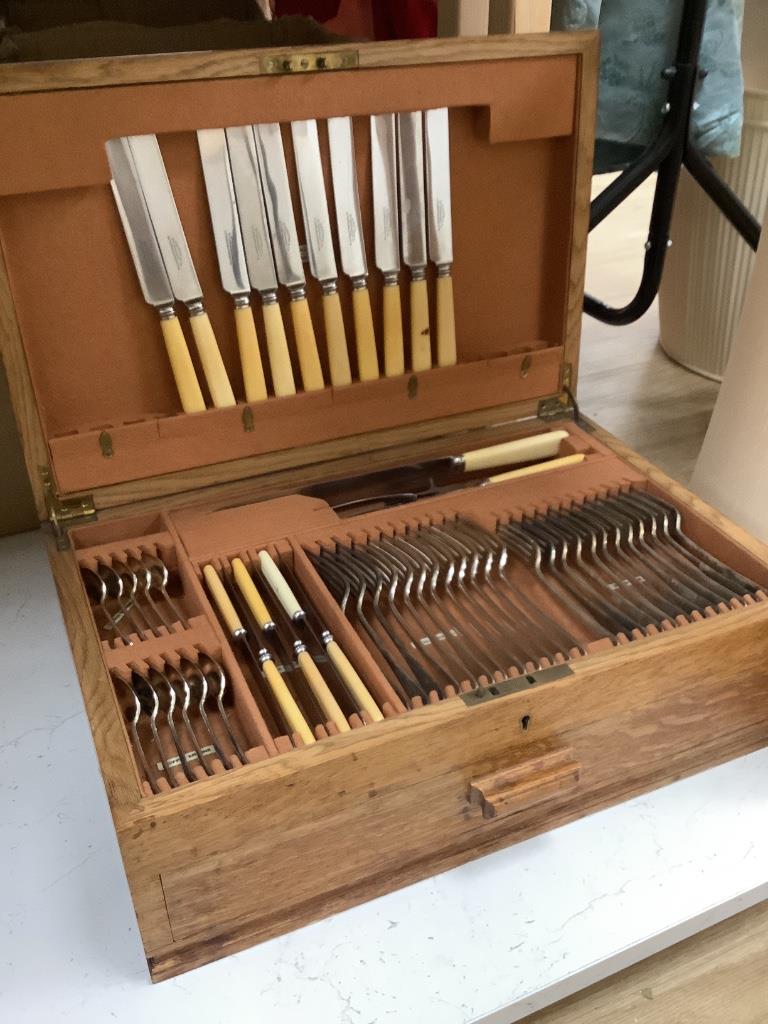 An oak cased plated part canteen of cutlery